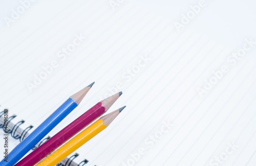 Hand with pencil writing something isolated on white background with shadows