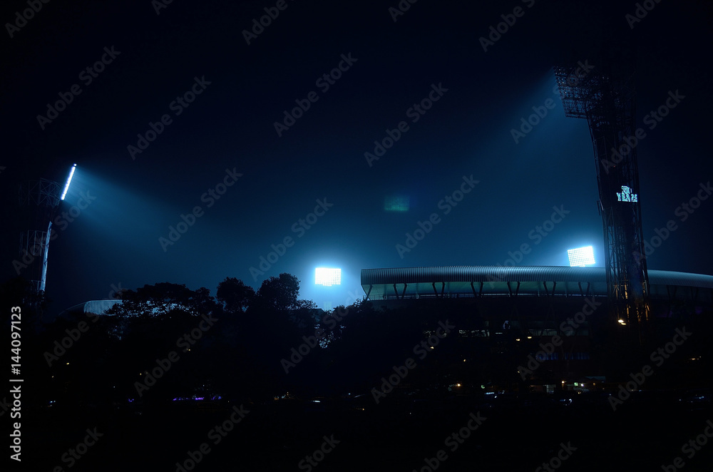 Stadium floodlights against a dark night