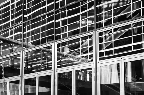 Black and White fascade of Office building with reflections in the windows photo