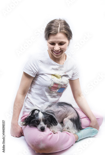 girl with dog on her knees isolated on white background (inscription - love is the happiness for two) 