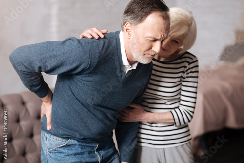 Senior man with terrible backache near wife © zinkevych