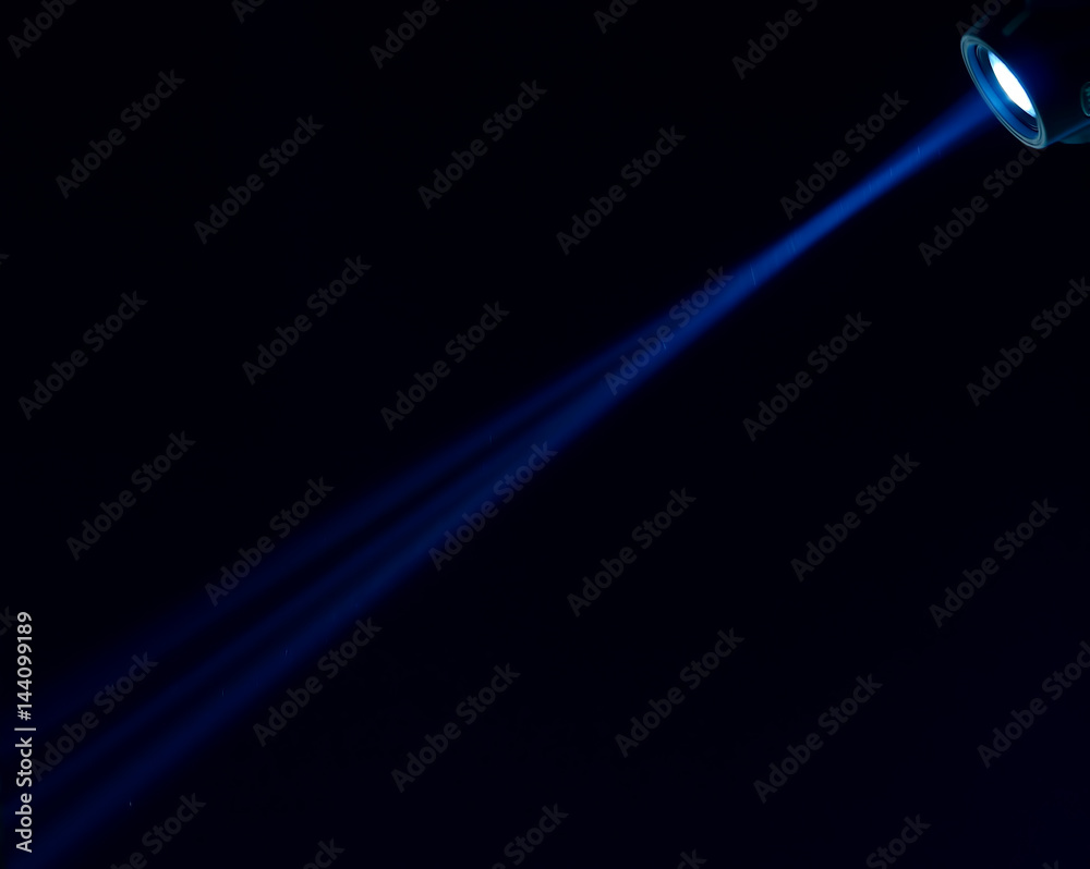 Fototapeta premium Beam of blue light on black . Applied to a searchlight torch