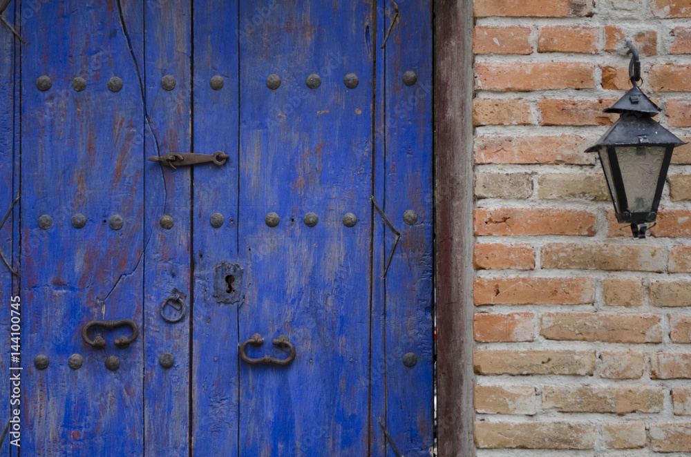 Detail of an old door and lantern on street