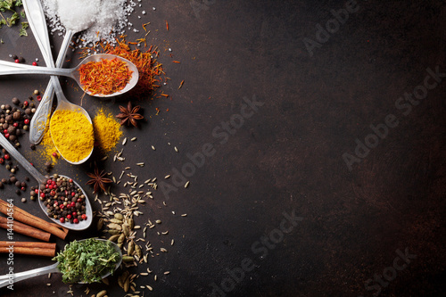 Fototapeta Naklejka Na Ścianę i Meble -  Various spices spoons on stone table