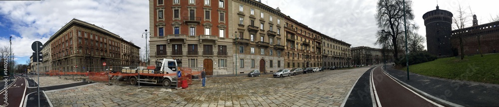 Fototapeta premium A panorama of moden cityscape justaposed with Sforzesco Castle of Milan, with road works in preparation for World Expo 2015