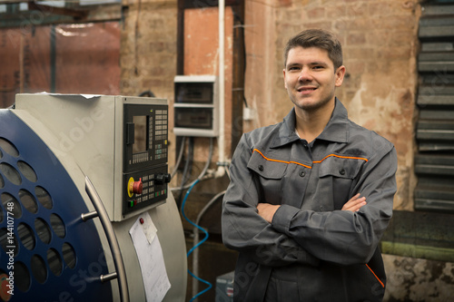 Professional machine operator on production plant photo