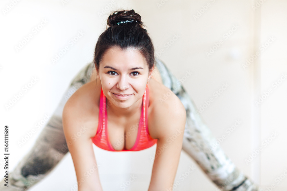 Close-up, portrait of a brunette woman practicing yoga, Ardha Padmasana pose, mudra, working out Close-up, portrait of a brunette woman practicing yoga, Ardha Padmasana pose, mudra, working out