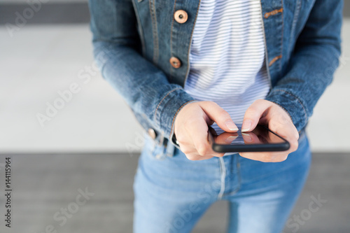 Woman using mobile smartphone. Modern or artistic concept. Close-up smartphone approach.