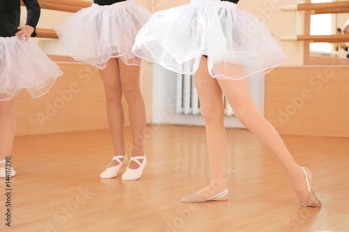 Legs of cute little girls training in dance studio