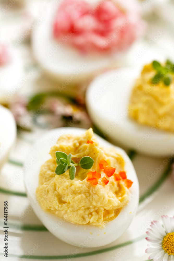 Deviled egg topped with fresh herbs and habanero pepper Deviled egg topped with fresh herbs and habanero pepper