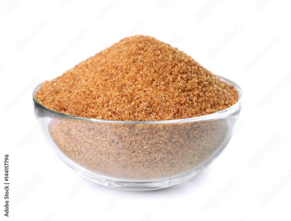 Heap of brown sugar in bowl, isolated on white