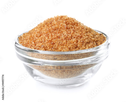 Heap of brown sugar in bowl, isolated on white