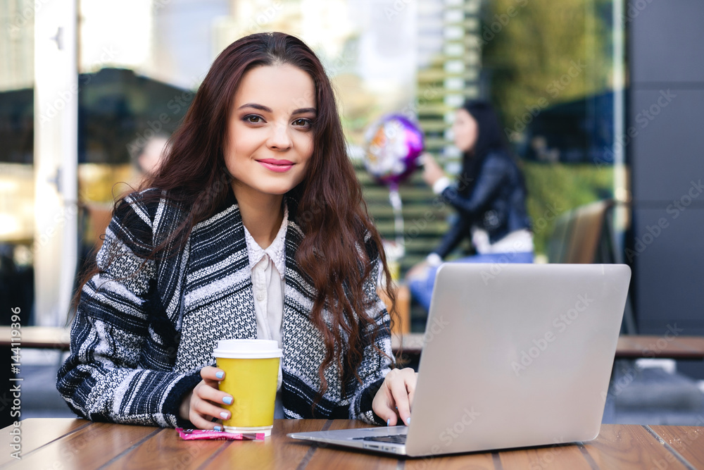 beautiful girl in the city of coffee, sits