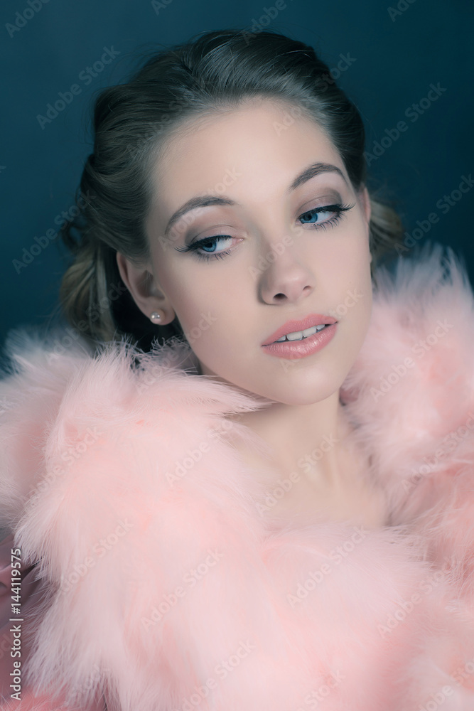 Sensual retro 1940s glamour portrait of young woman wearing feather boa. Sensual retro 1940s glamour portrait of young woman wearing feather boa.