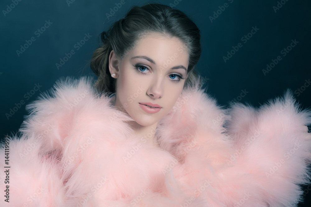 Sensual retro 1940s glamour portrait of young woman wearing feather boa. Sensual retro 1940s glamour portrait of young woman wearing feather boa.