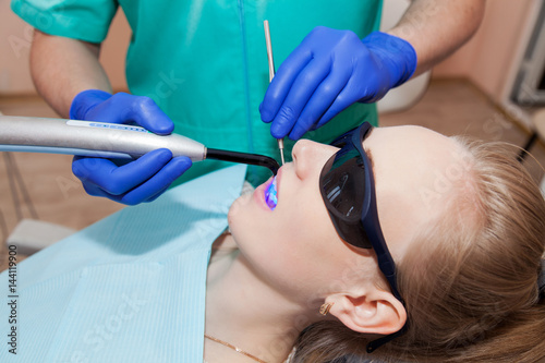 Dentist working with ultraviolet lamp