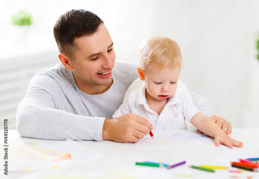 father and baby son paint together father and baby son paint together