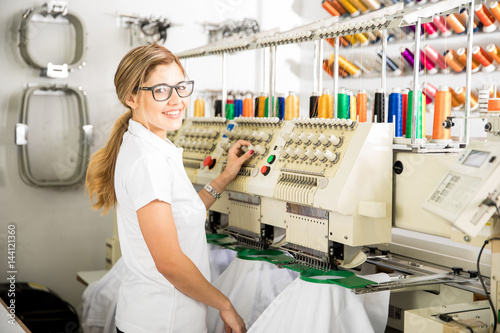 Woman working in a textile factory doing embroidery