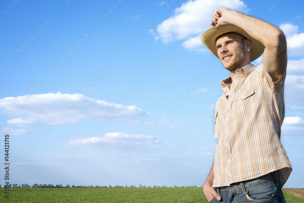 Agriculture. Farmer standing in the wheat field on a sunny day. Agronomy, faming, husbandry concept. Happiness. Satisfaction. Agriculture. Farmer standing in the wheat field on a sunny day. Agronomy, faming, husbandry concept. Happiness. Satisfaction.