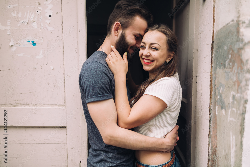 Young and stylish couple walking on the street of summer. Bearded boy and fashionable girl are loving and flirting. Young and stylish couple walking on the street of summer. Bearded boy and fashionable girl are loving and flirting.