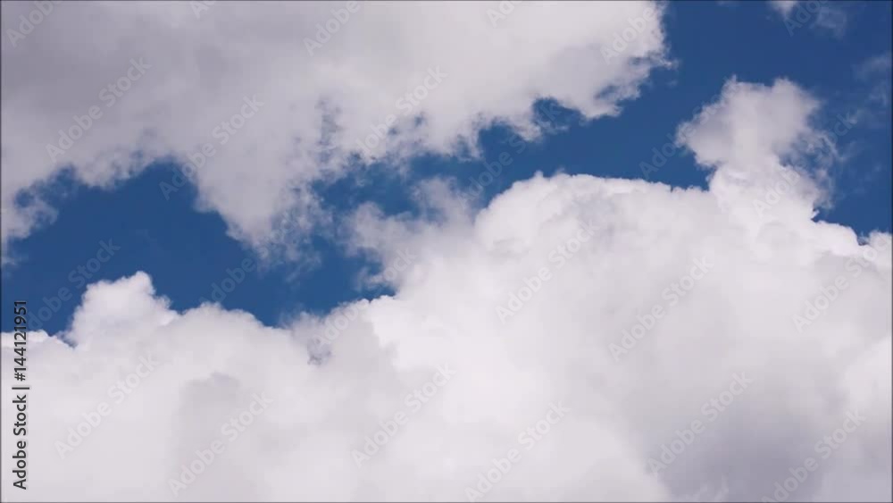 White clouds move across clear blue sky. Cloudy blue sky background. White clouds move across clear blue sky. Cloudy blue sky background.