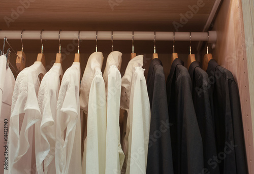 White and black shirts on trempele in the closet