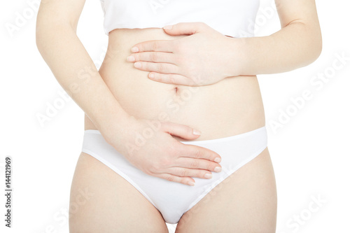 Young woman with menstrual pain isolated on white, clipping path