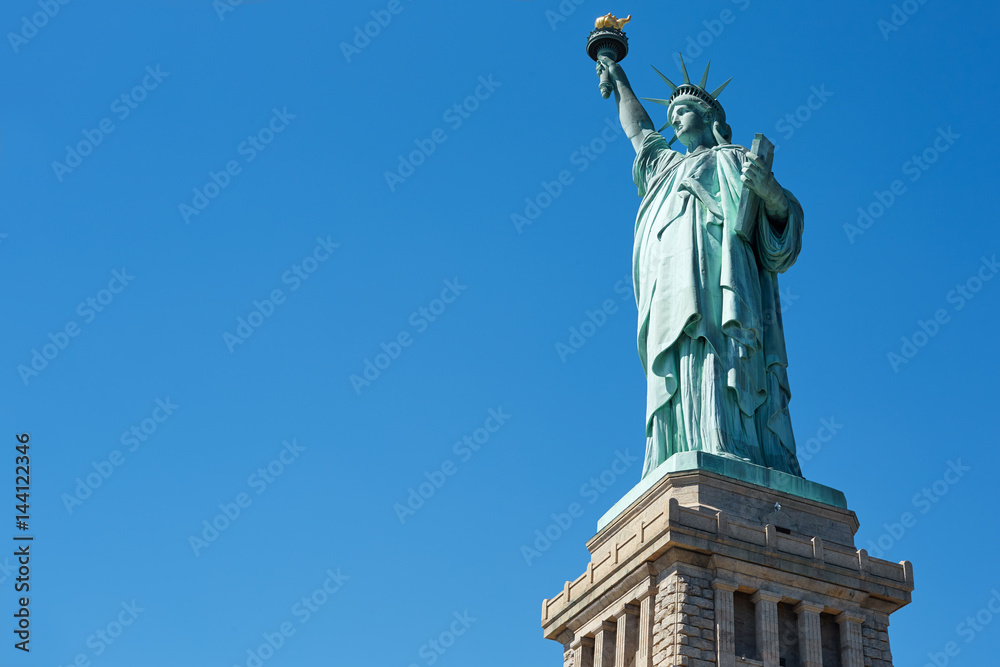 Statue of Liberty on clear blue sky in a sunny day, low angle view with clipping path