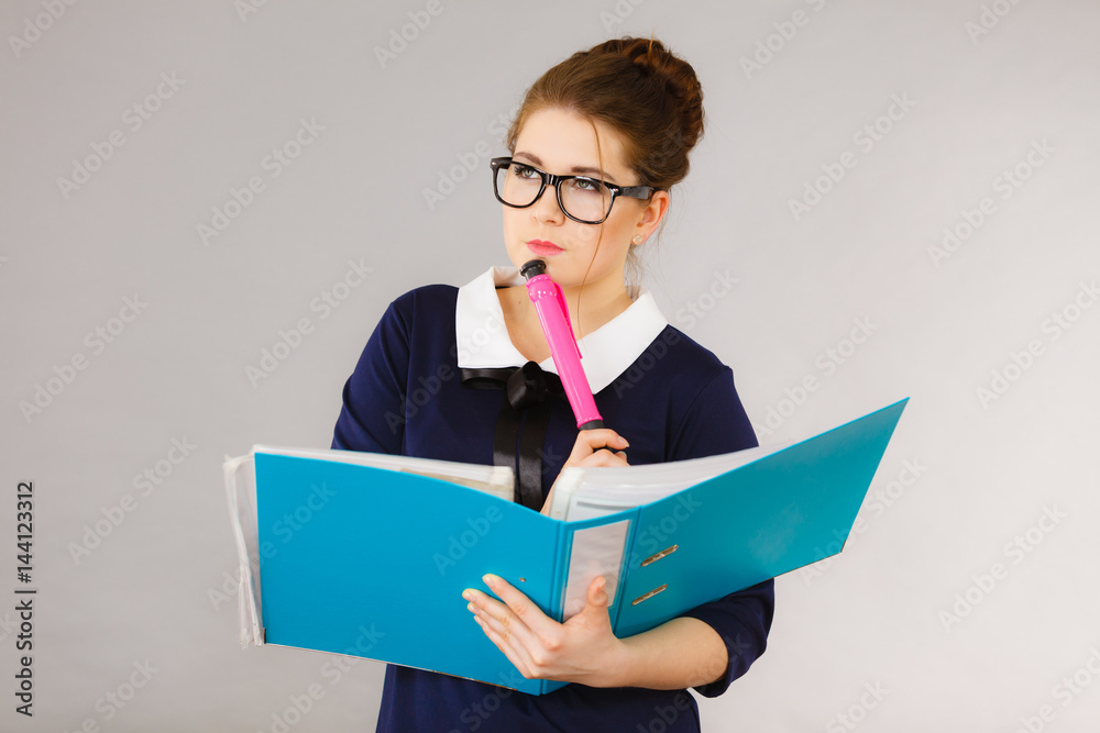 woman thinking holds file folder with documents woman thinking holds file folder with documents