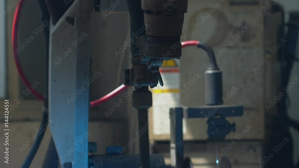 CU shot of robot arm welding car part on a factory. Industrial process, no people. 4K UHD 60 FPS CU shot of robot arm welding car part on a factory. Industrial process, no people. 4K UHD 60 FPS