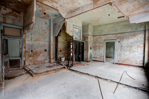 Old abandoned building in decay with broken glass and building materials
