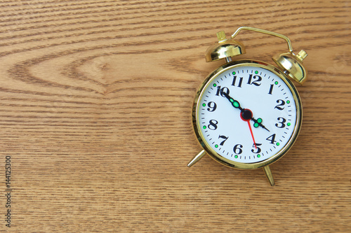 retro alarm clock on wooden table