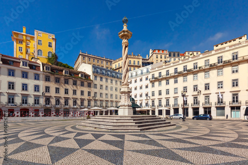 Town Hall Square with a beautiful geometric mosaic in Lisbon, Portugal. In the center of the square the pillory The Pelourinho de Lisboa photo