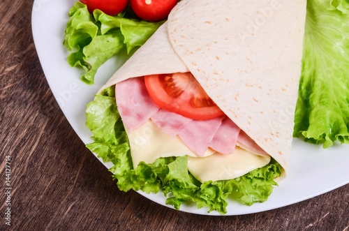 Burito with ham, cheese and tomatoes