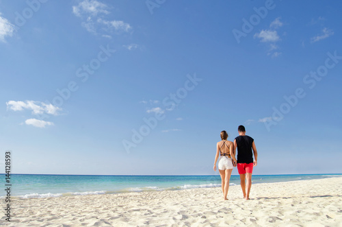 Couple walking at the beach