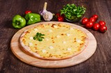 Thin pizza with cheese. Four types of cheese