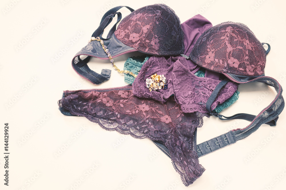 Set of woman accessories. Vintage style sexy lace woman lingerie. Glamorous  chameleon colorful stylish pants, bras, ring and necklace. Selective soft  focus Stock Photo