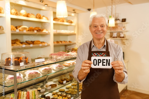 Happy senior man opening his own bakery © Nestor
