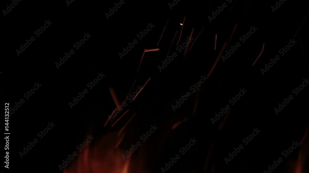The sparks fly out of fire. Isolated on black background. The sparks fly out of fire. Isolated on black background.