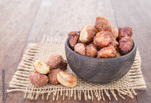 sugared peanuts on the wooden background