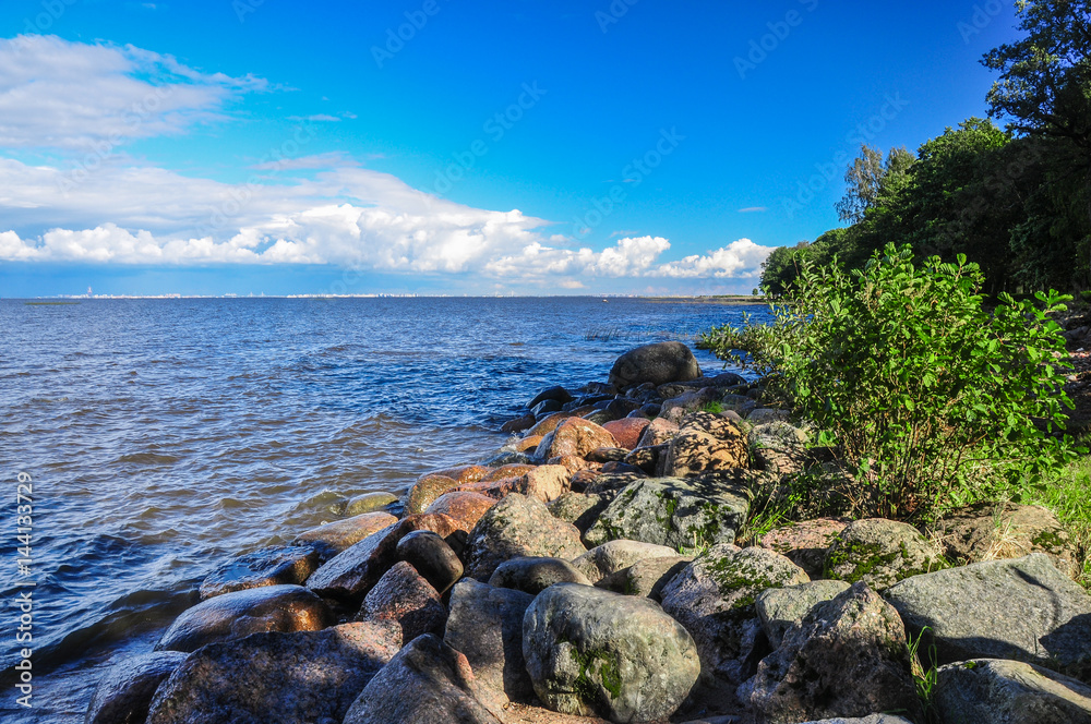 Landscape of Stony shore of the Gulf of Finland and Saint-Petersburg on the horizon. View from Peterhof park Landscape of Stony shore of the Gulf of Finland and Saint-Petersburg on the horizon. View from Peterhof park