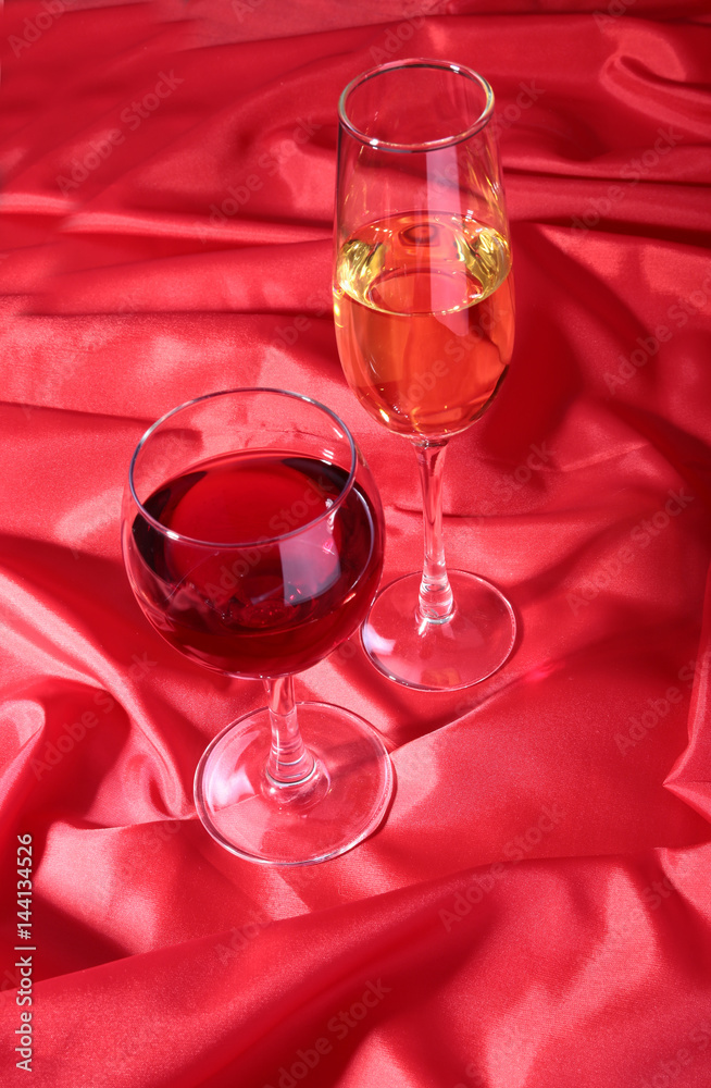 Two Glass of red, white wine on red background