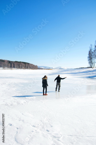 Couple skating on the frozen lake