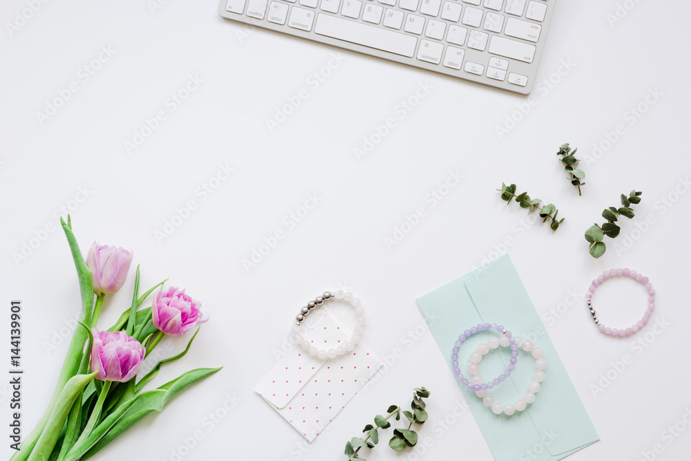 Spring flowers on workdesk at home white background top view mockup Spring flowers on workdesk at home white background top view mockup