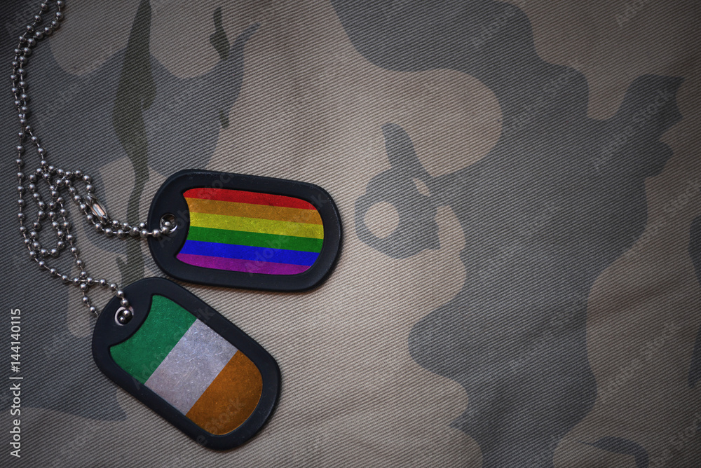 Φωτογραφία army blank, dog tag with flag of ireland and gay rainbow flag on the khaki texture background