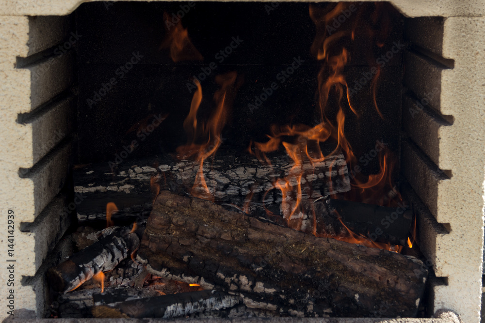Wood burning on a fireplace with high flames Wood burning on a fireplace with high flames