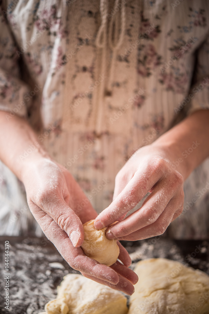 Housewife making dough for dumplings or pasta