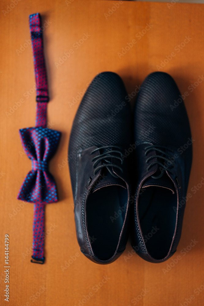 Men's shoes and bow tie. Wedding accessories and groom clothes.