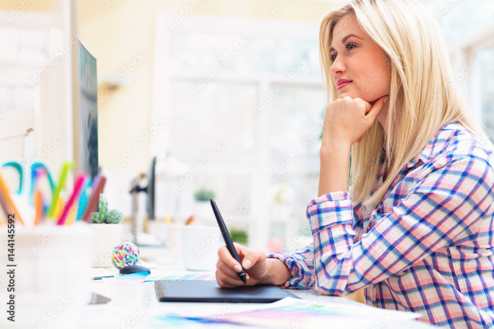 Graphic designer using her graphic tablet Graphic designer using her graphic tablet