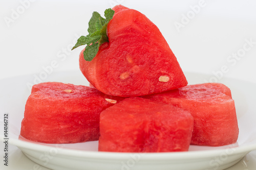 Watermelon on  white plate and wooden background. photo